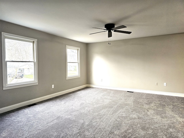 carpeted empty room featuring ceiling fan