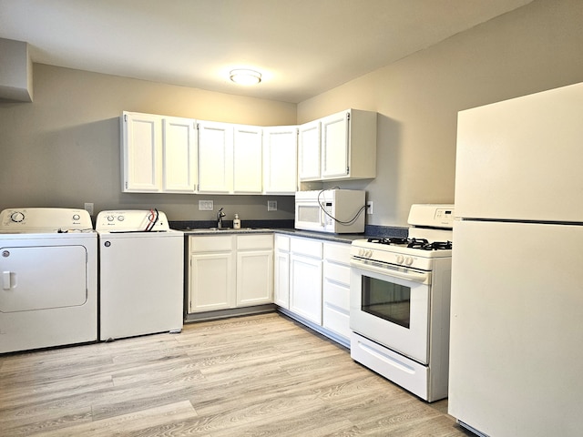 kitchen featuring white appliances, sink, separate washer and dryer, light hardwood / wood-style flooring, and white cabinetry