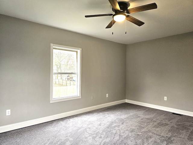 spare room featuring carpet and ceiling fan