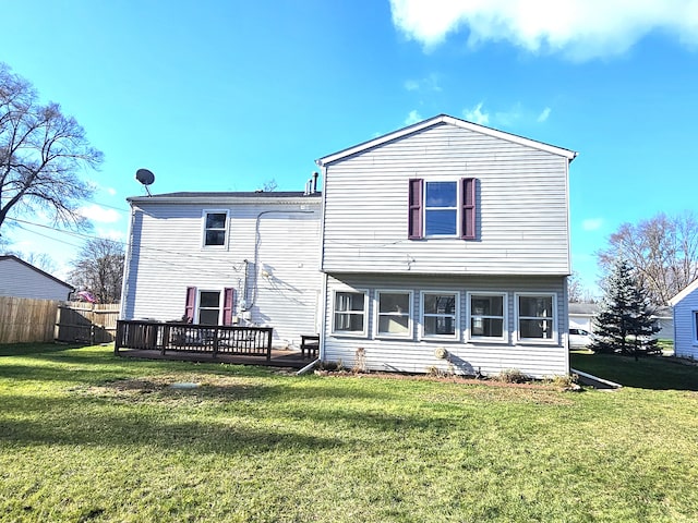 back of property featuring a yard and a wooden deck