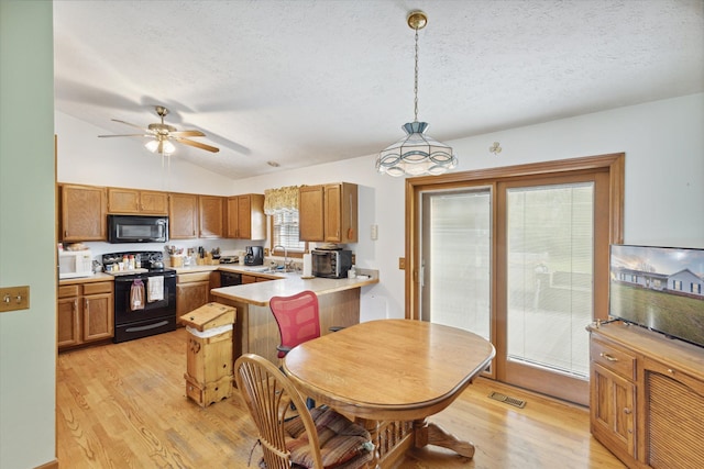 kitchen featuring kitchen peninsula, a textured ceiling, black appliances, pendant lighting, and lofted ceiling