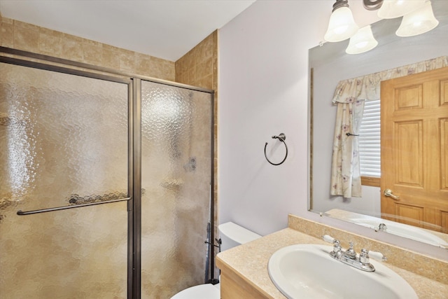 bathroom with vanity, toilet, and walk in shower