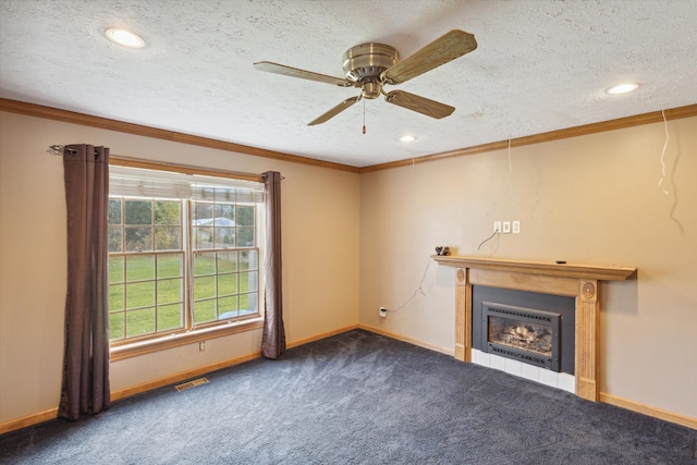 unfurnished living room featuring ceiling fan, ornamental molding, a textured ceiling, and dark colored carpet