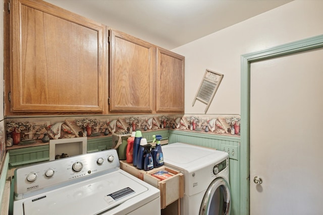 laundry area with cabinets and separate washer and dryer