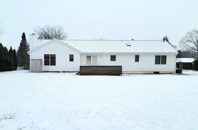 snow covered back of property with central AC unit