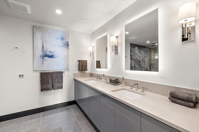 bathroom with tile patterned flooring, vanity, and walk in shower