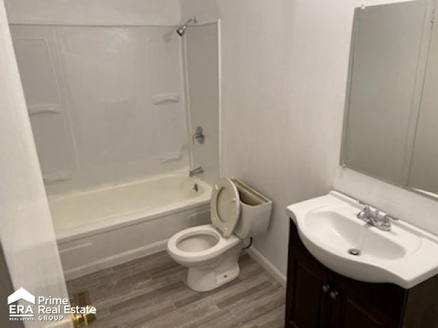 full bathroom with shower / tub combination, hardwood / wood-style floors, vanity, and toilet