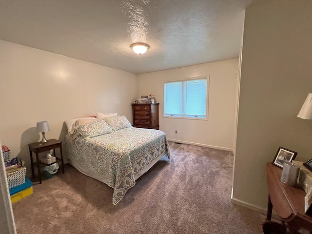 carpeted bedroom featuring a textured ceiling