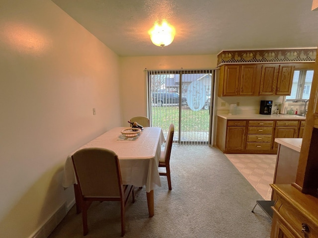 dining room featuring a textured ceiling and a healthy amount of sunlight