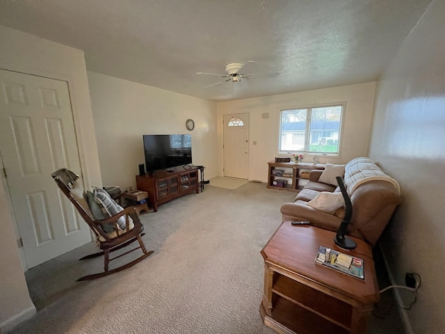 living room featuring ceiling fan and carpet floors