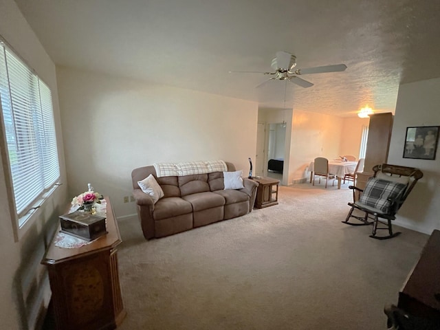 carpeted living room featuring ceiling fan