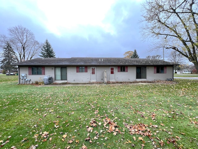 single story home with a front yard and a patio area