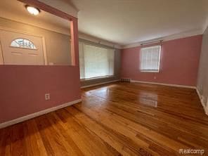 interior space featuring hardwood / wood-style floors and crown molding