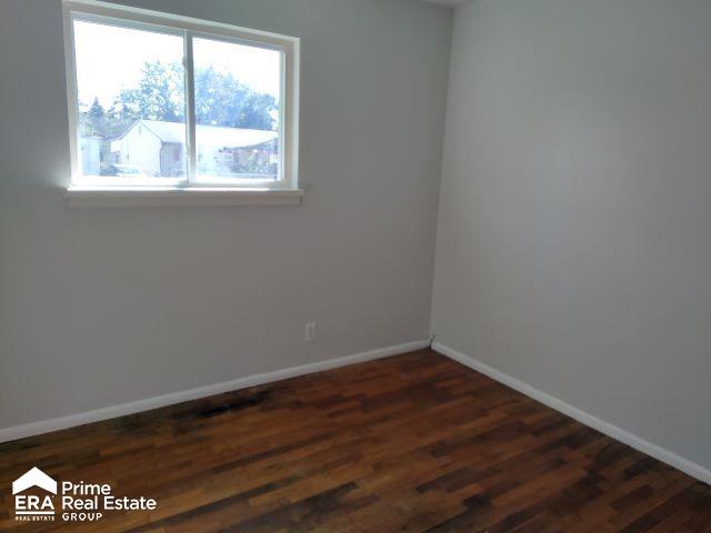 empty room featuring dark wood-type flooring