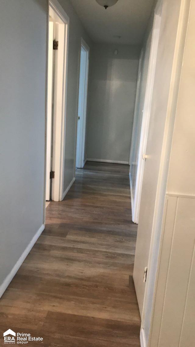 hallway with dark wood-type flooring