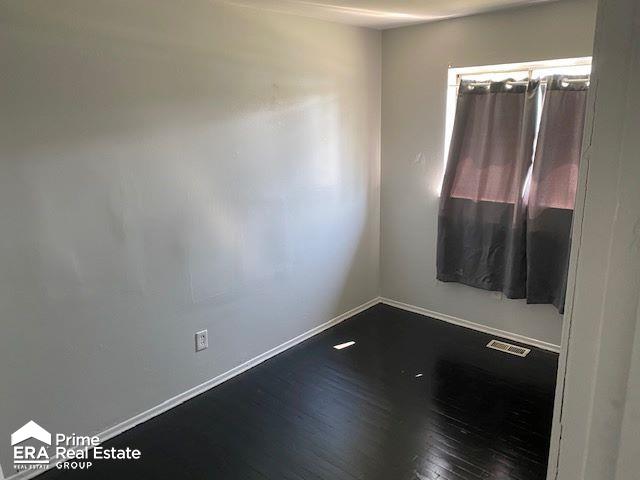 spare room featuring hardwood / wood-style floors