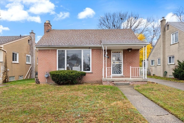 bungalow-style home with a front lawn