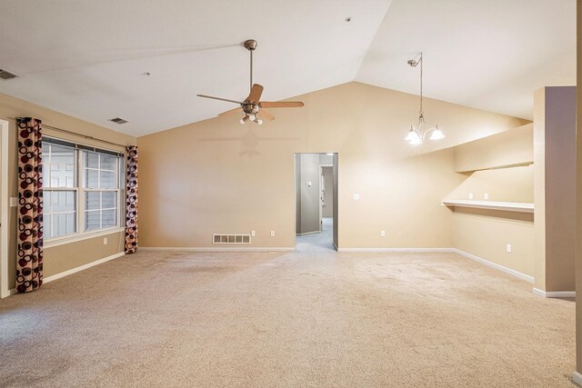 unfurnished room with ceiling fan with notable chandelier, carpet floors, and lofted ceiling