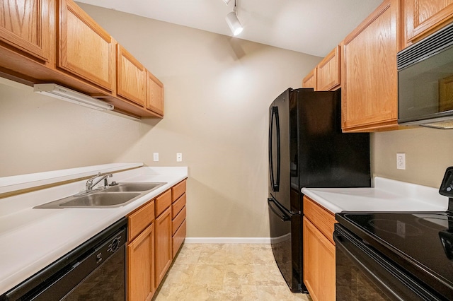 kitchen featuring sink, vaulted ceiling, and black appliances