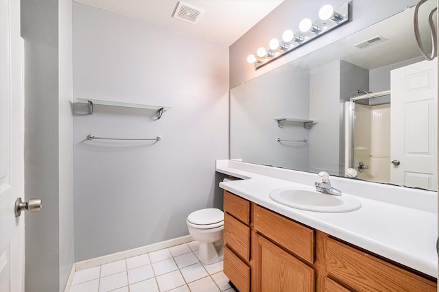 bathroom with tile patterned floors, vanity, toilet, and a shower with door