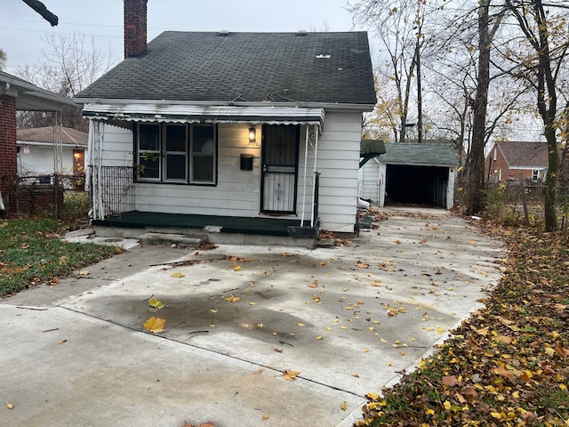 back of house with a storage shed