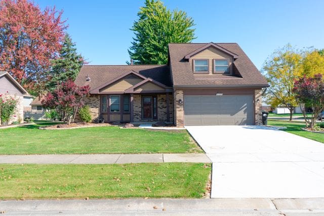 view of front of property with a front yard and a garage