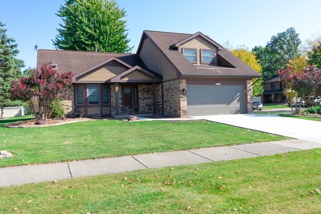 view of front of house with a front yard and a garage