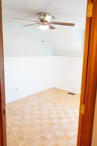 bonus room featuring light parquet floors and ceiling fan