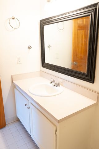 bathroom with tile patterned floors and vanity