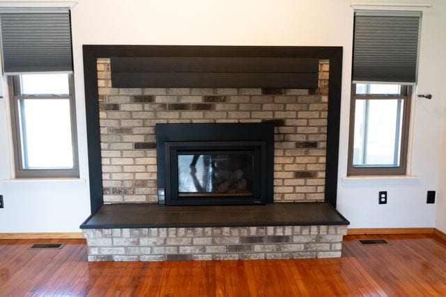 details with a fireplace and wood-type flooring