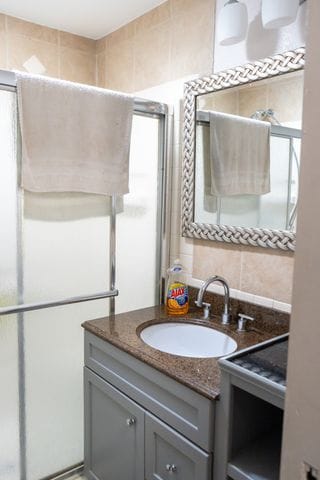 bathroom with vanity and an enclosed shower