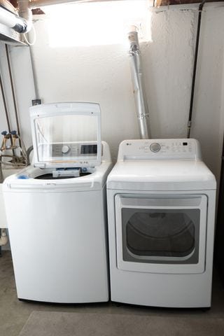 clothes washing area with independent washer and dryer