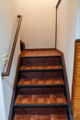 staircase with wood-type flooring