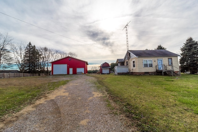 view of front facade with a garage, an outdoor structure, and a front yard