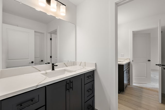 bathroom with hardwood / wood-style floors and vanity