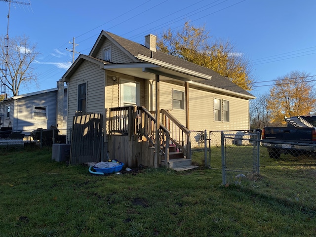 2298 S Term St, Burton, MI 48519 - back of house with cooling unit, a chimney, and a shingled roof