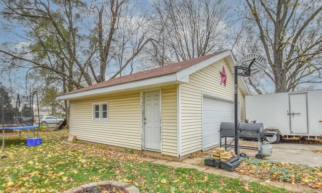 view of outdoor structure featuring a garage and a trampoline