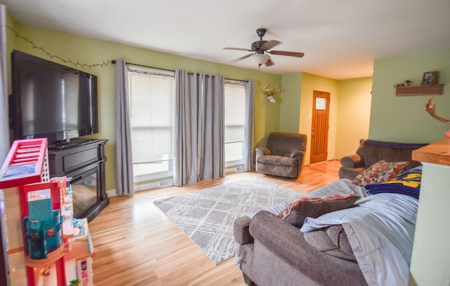 living room featuring light wood-type flooring and ceiling fan