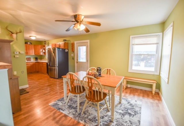 dining area featuring ceiling fan, a healthy amount of sunlight, and light hardwood / wood-style floors