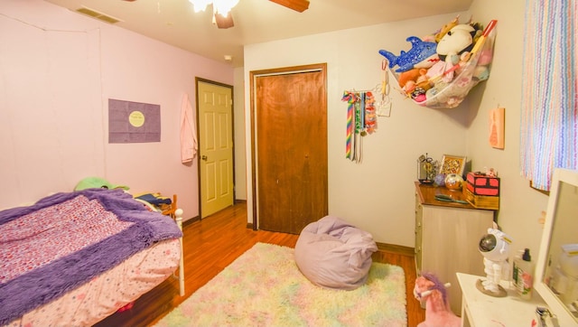 bedroom featuring wood-type flooring, a closet, and ceiling fan