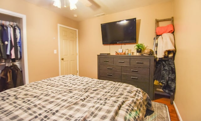 bedroom featuring hardwood / wood-style floors, a closet, and ceiling fan