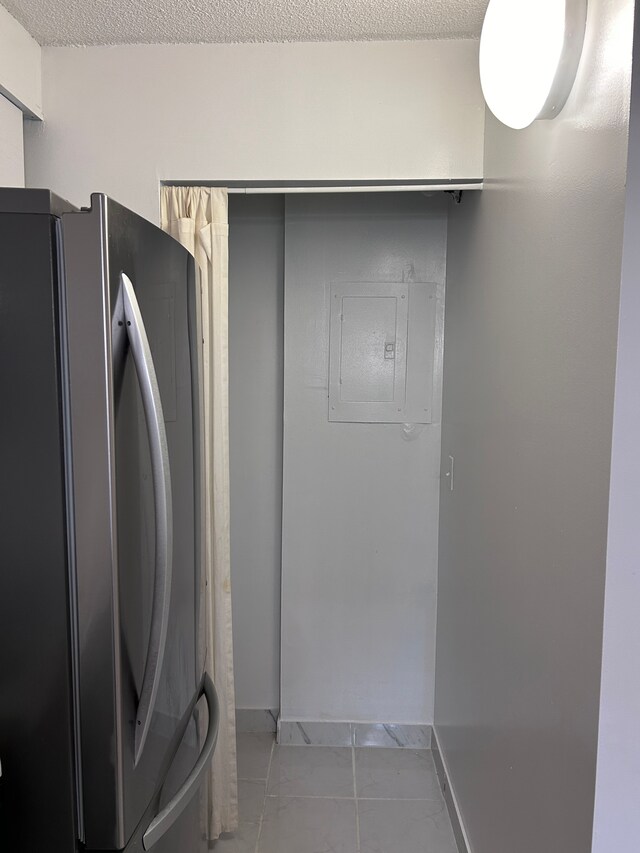 21800 Morley Ave Unit 101, Dearborn, MI 48124 - laundry room featuring electric panel, light tile patterned flooring, baseboards, and a textured ceiling