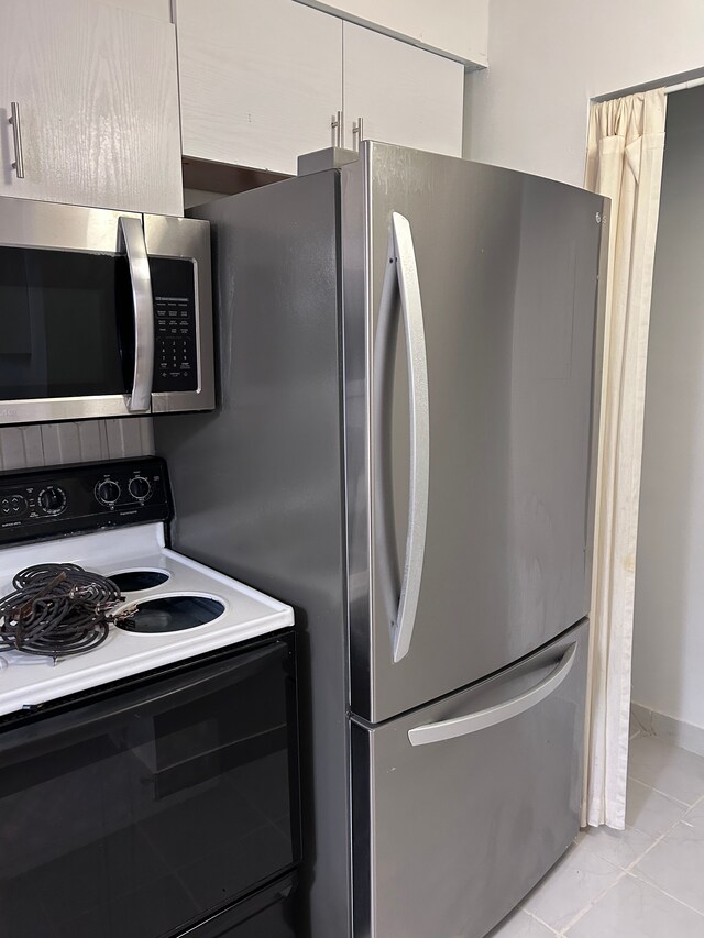 21800 Morley Ave Unit 101, Dearborn, MI 48124 - kitchen with appliances with stainless steel finishes and light tile patterned floors