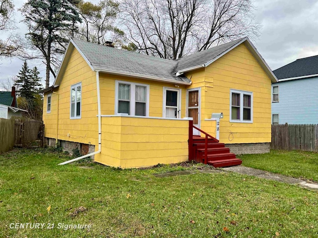 rear view of property with a yard