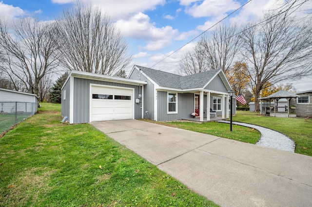 ranch-style house with covered porch, a front yard, and a garage