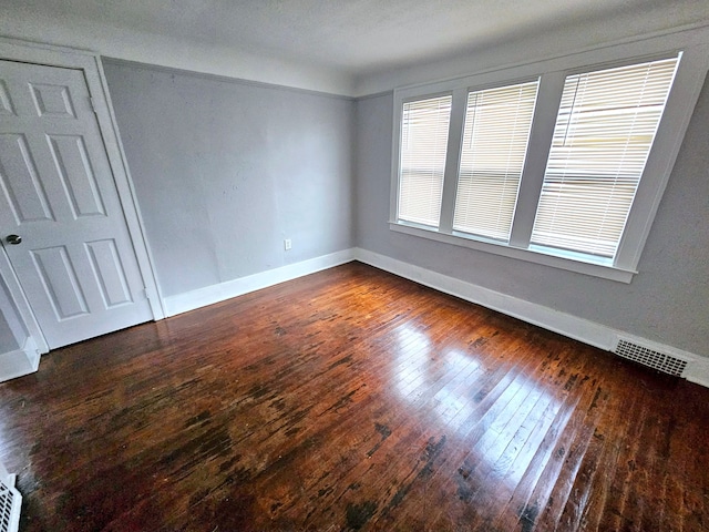 spare room with dark hardwood / wood-style floors