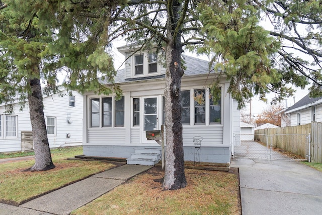 bungalow-style home featuring a front yard