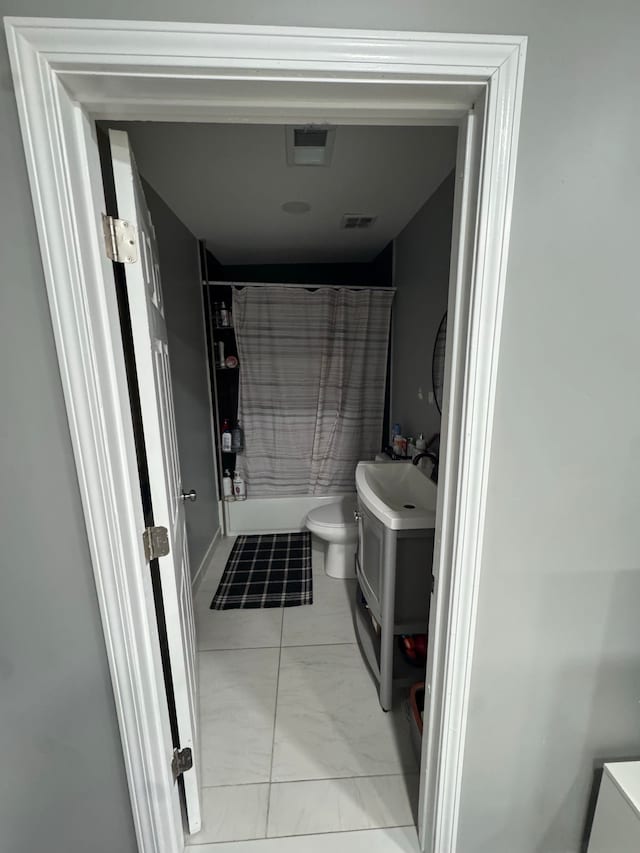 full bathroom featuring shower / bath combo, toilet, and vanity