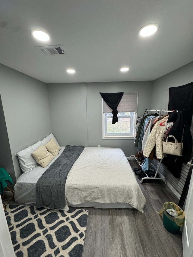 bedroom with dark hardwood / wood-style floors