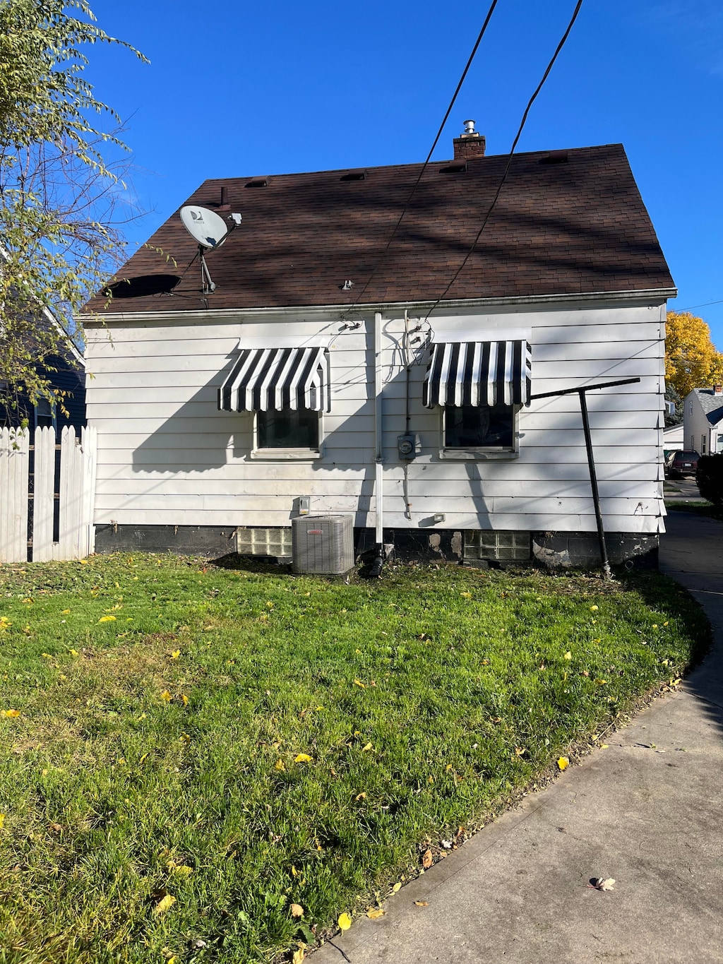 exterior space featuring a lawn and cooling unit